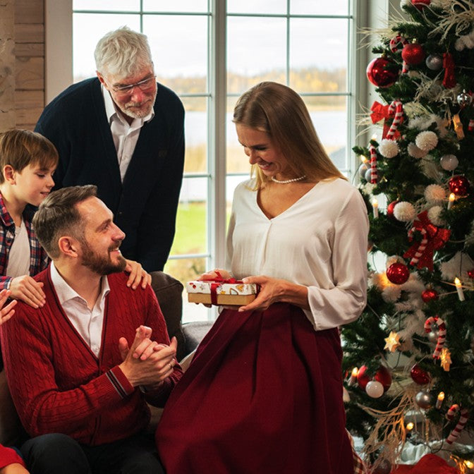 Family enjoying Christmas gift exchange